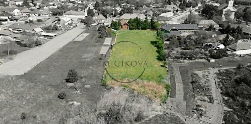 Aerial view of a large garden and surrounding family houses in the village of Čifáre.