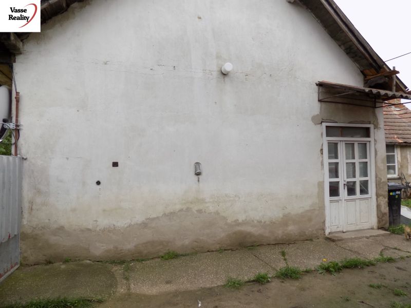 A family house in Gbelce in Gbelce with plaster, next to the gate and willow fence.