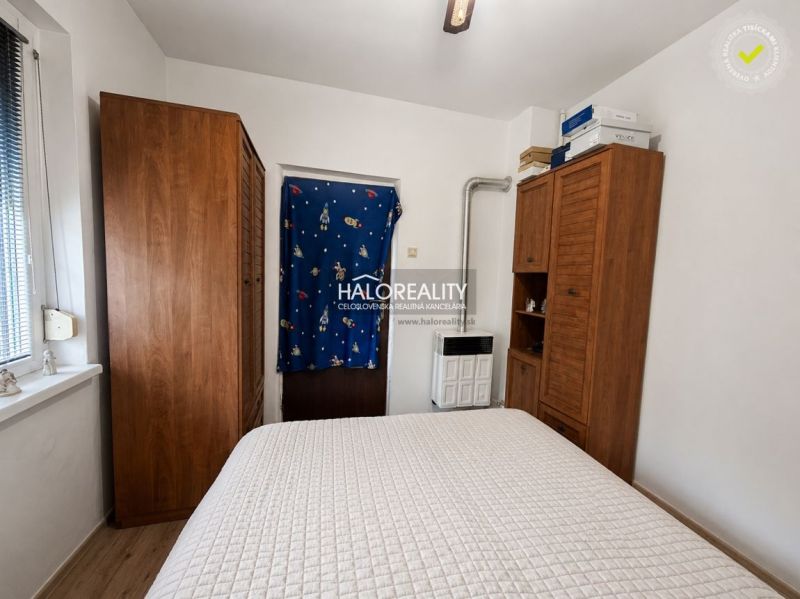A bedroom in a family house with wardrobes and a wooden decor floor.