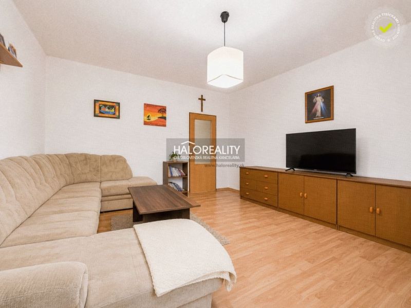 Living room in a family house with a corner sofa and a wooden decor floor.