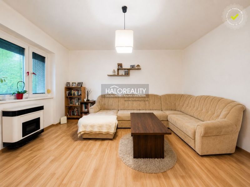 Living room in a family house with a corner sofa and a wooden decor floor.