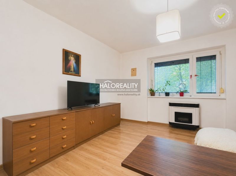 Living room in a family house with a television and a wooden decor floor.