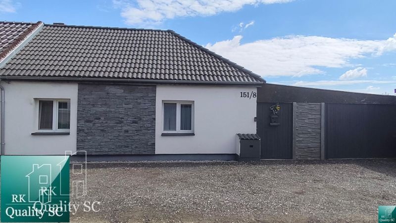 The family house on Mlynska Street in Blatne has a white facade and stone cladding.
