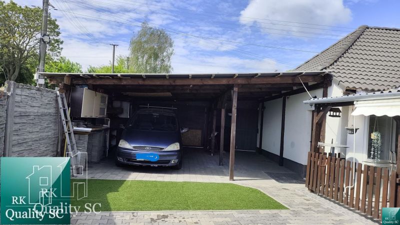A garage with a car at a family house on Mlynska Street in Blatne.