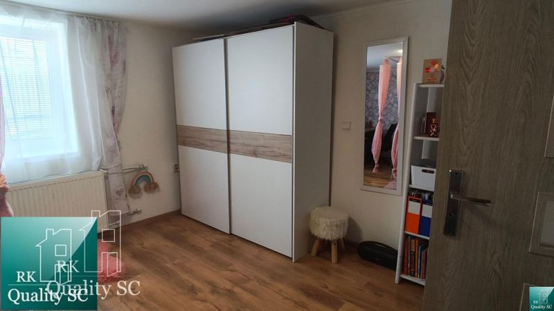 Interior of a family house with a white wardrobe and a wooden decor floor.