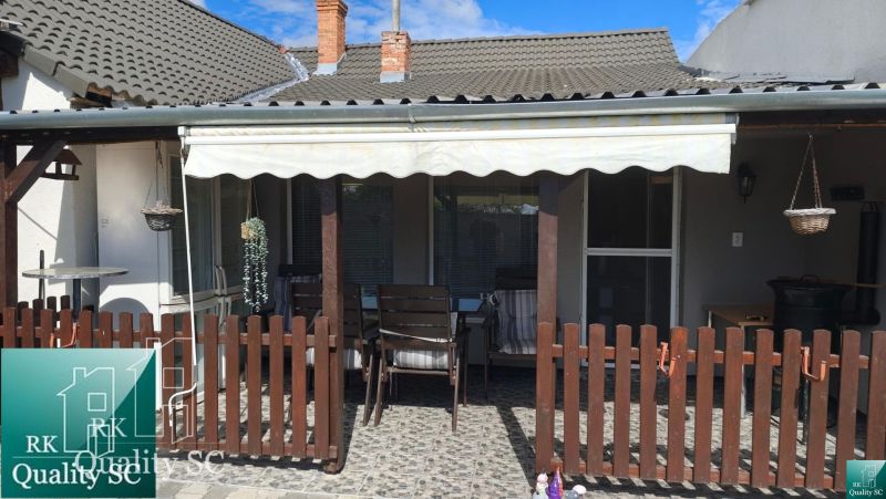 The terrace of a family house on Mlynska Street in Blatné with a wooden fence and a shelter.