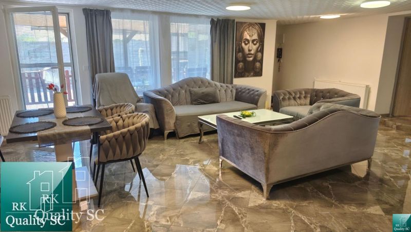 Living room in a family house with a comfortable sofa and marble floor.