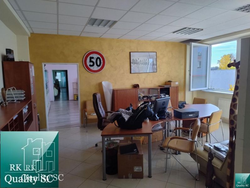 Office space with a desk, chairs, and a decorative object in the Production facilities.
