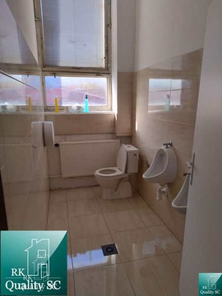A toilet with tiles and ceramic flooring in industrial production areas.