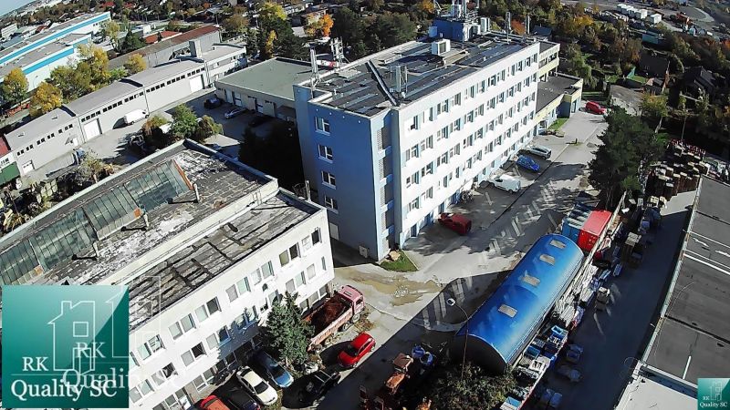 Buildings and warehouses on Staviteľská Street in Bratislava III with a large number of vehicles and goods.