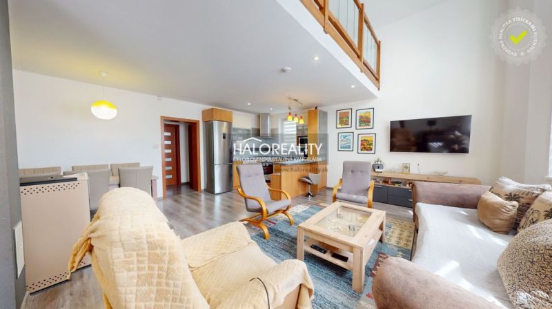 A family house with a wooden decor floor, spacious living room, and dining area.