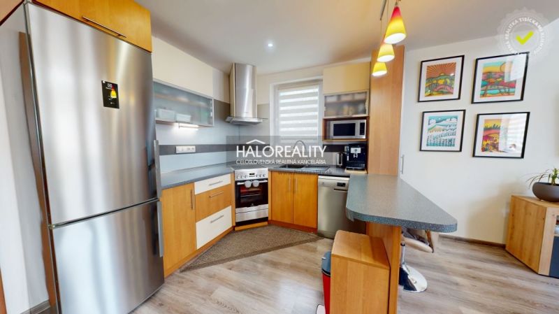 A kitchen in a family house with wood decor flooring and modern equipment.