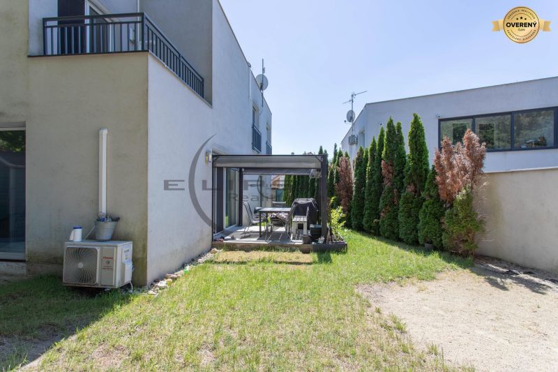 The backyard of a family house in Stupava with a terrace and lawn.