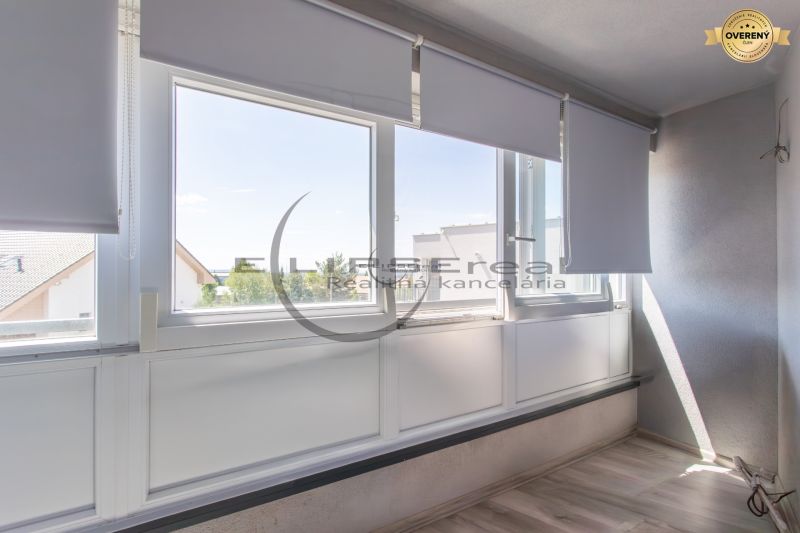 Glazed balcony with blinds and a view in a family house in Stupava.