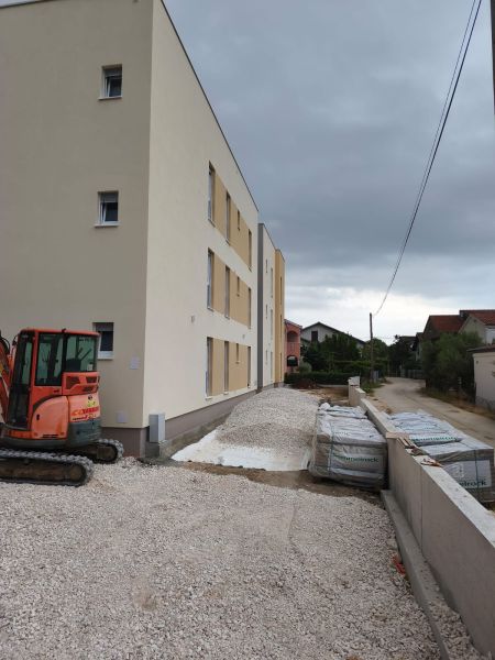Construction site with a three-story building and a construction site for a 3-room apartment in Sukošan.
