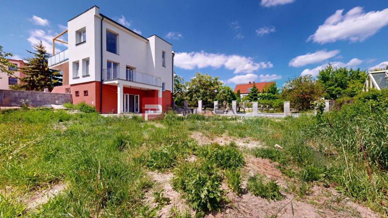 A family house on Sládkovičova Street in Modra is surrounded by a grassy plot.