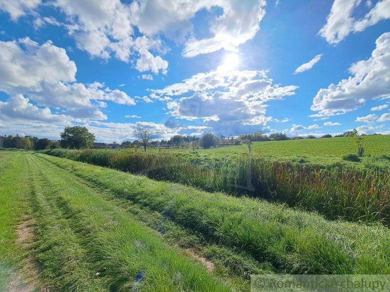 Beautiful greenery and vast fields around Hruboňovo, Záhrady, under the blue sky.