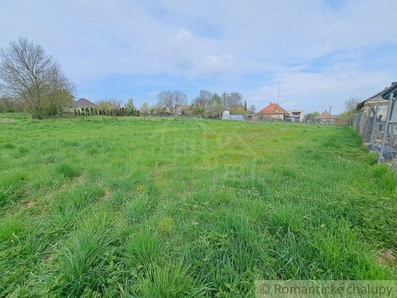 Gardens in Hruboňovo with expansive grassy areas and rural houses in the background.