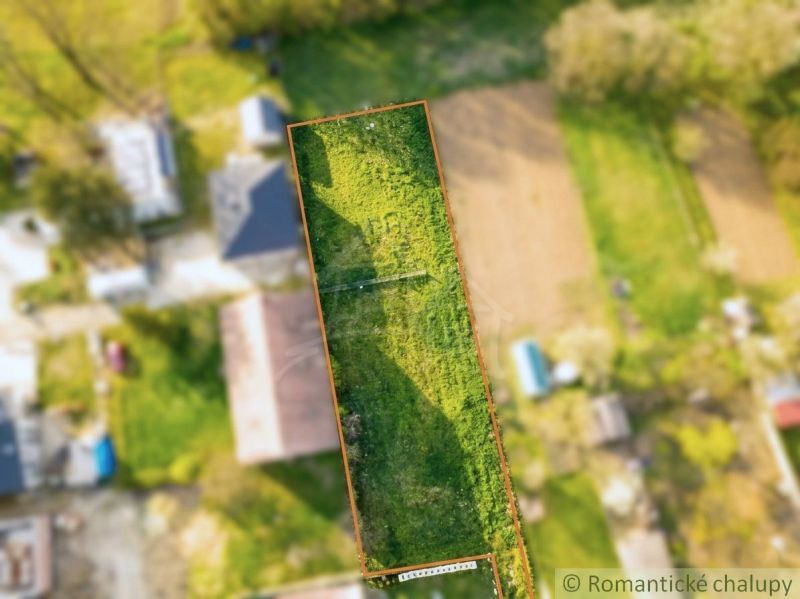 Aerial view of the gardens in Hruboňovo with a vast green lawn in the center.