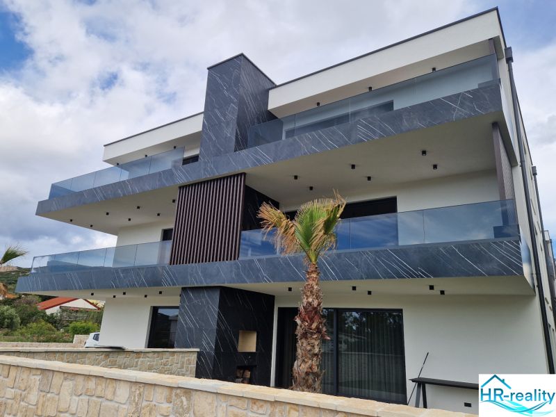 A recreational apartment in Stara Novalja with modern architecture and spacious terraces.
