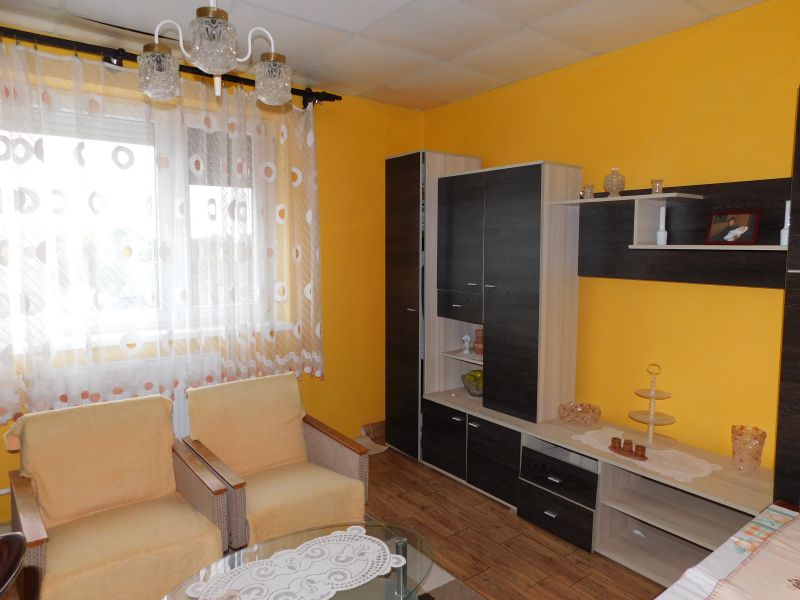 Living room in a family house with a wooden decor floor and furniture.