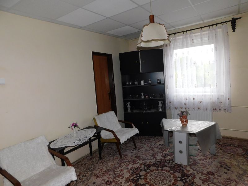 Living room in a family house with carpet and custom-made furniture.