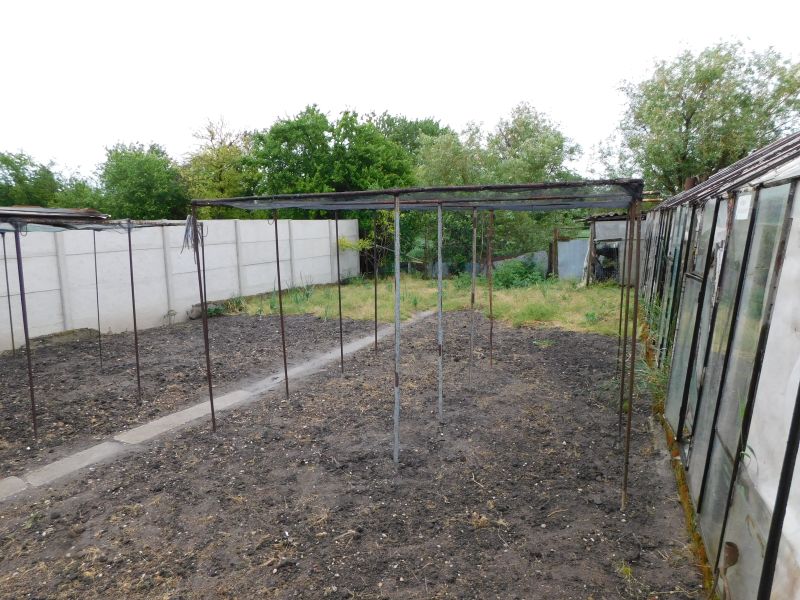 A garden at a family house in Dvory nad Žitavou, with empty supports for plants.