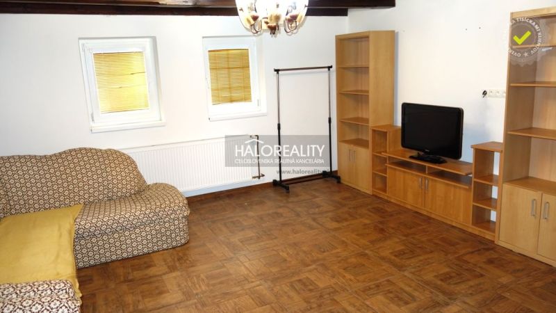 Living room in a family house with a shelving unit and a wooden decor floor.