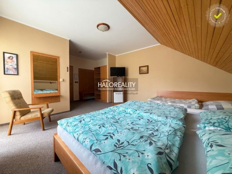 Interior of a hotel room with a double bed, an armchair, and a mirror, Hotels and guesthouses.