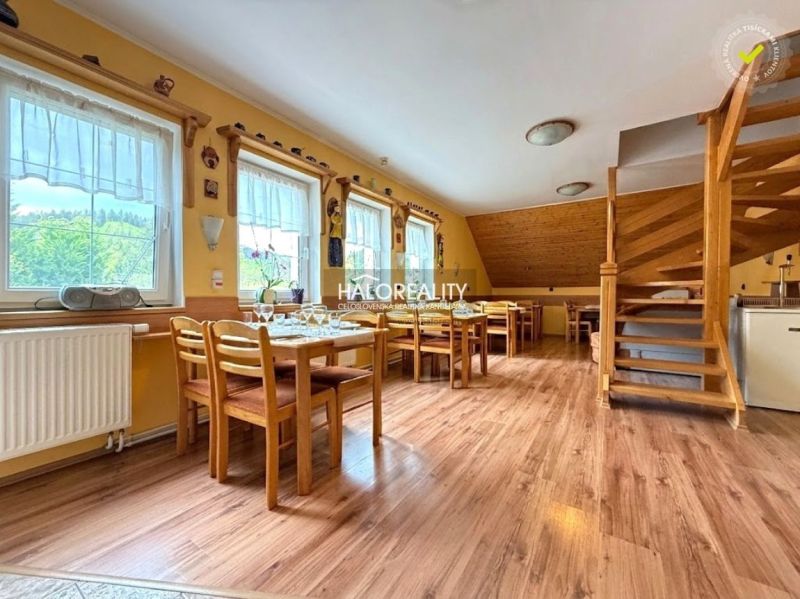 Bright dining room with wood-patterned flooring, ready to host guests.