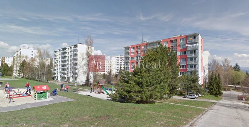 Sandbox and apartment buildings on Fončorda Street in Banská Bystrica.