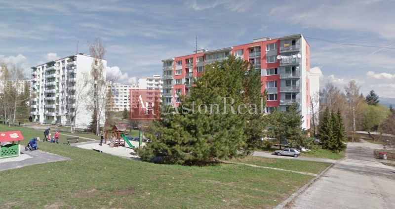 Housing estate scenery with a children's playground and apartment buildings in Fončorda, Banská Bystrica.