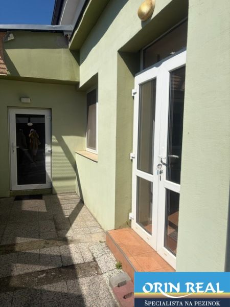 Entrance area of a 1-bedroom apartment on Záhradná Street in Pezinok with glass doors.