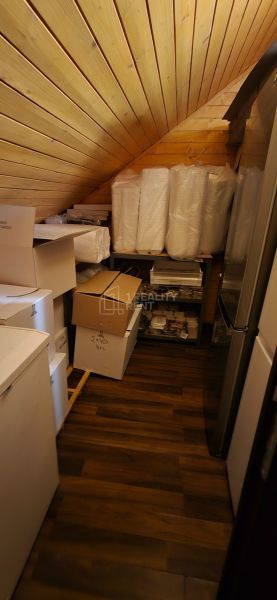 Storage space with wood-patterned flooring and various boxes in commercial premises.