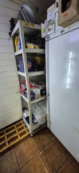 Storage space with shelves and consumer goods in commercial premises.