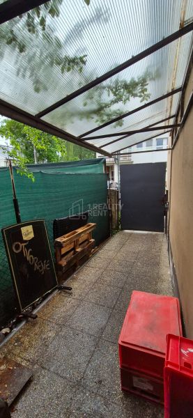 Exterior of commercial premises in Kysucké Nové Mesto with a covered terrace and a sign.