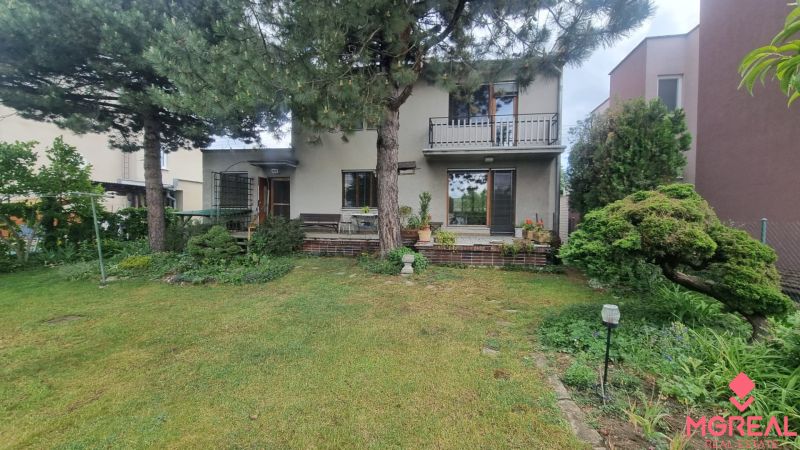 A family house in Leopoldov surrounded by a garden with a terrace and trees.