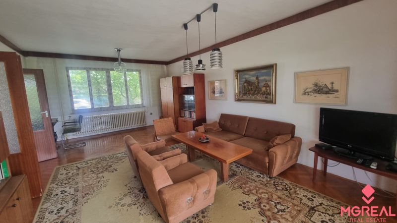 Living room of a family house with retro furniture and a wooden decor floor.