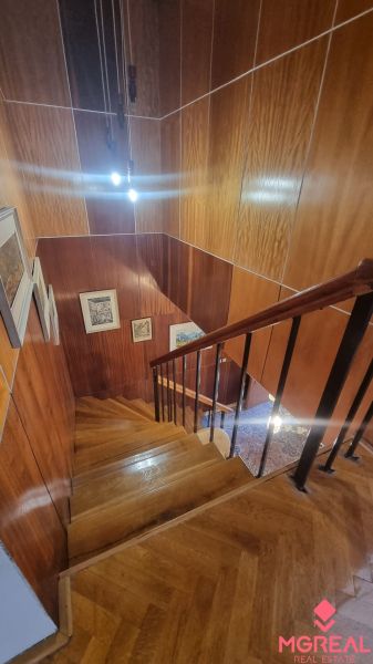 A staircase in a family house with wood decor and railing.