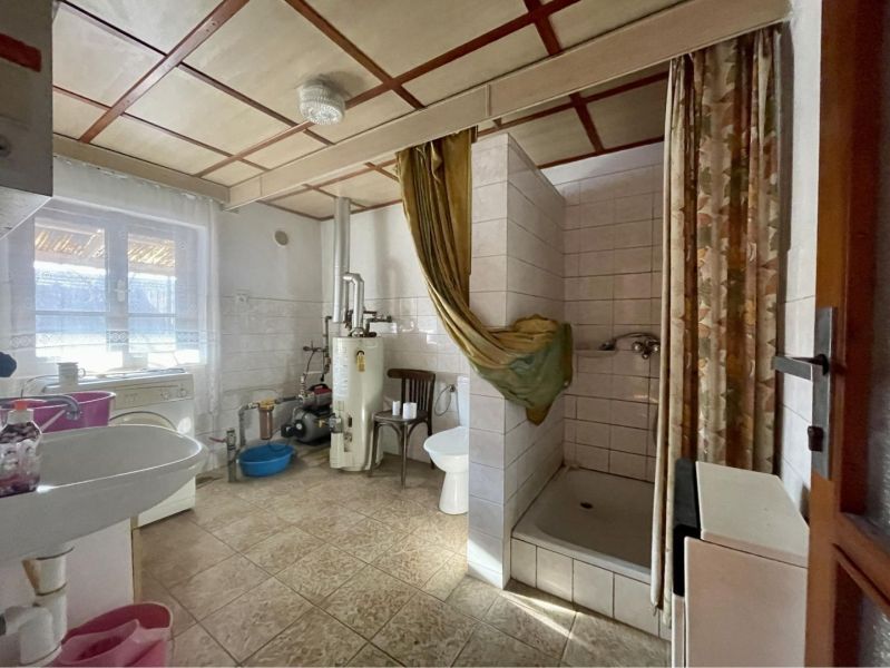 Bathroom with a sink, shower corner, and boiler, Land - living.