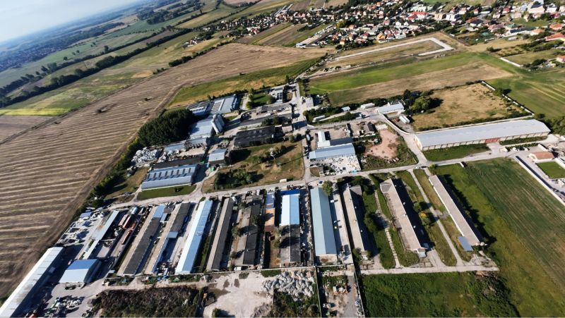 Aerial view of the production facilities in Kostolné Kračany at Amadeho Kračany surrounded by fields.