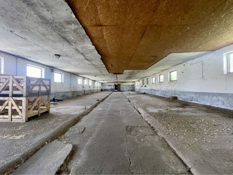 A space with a concrete floor and wooden crates in a manufacturing area.