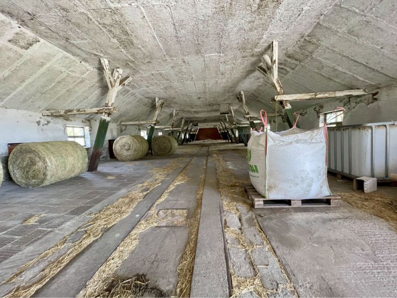 A barn with bales of hay in the production premises in Amadeho Kračany in Kostolné Kračany.