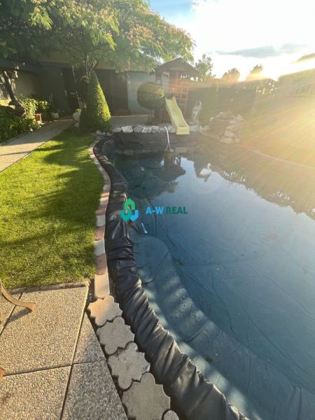 Garden of a family house in Orechová Potôň with a pool and a slide.