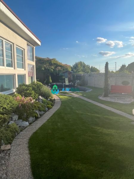 A garden at a family house in Orechová Potôň with a well-maintained lawn and walkway.