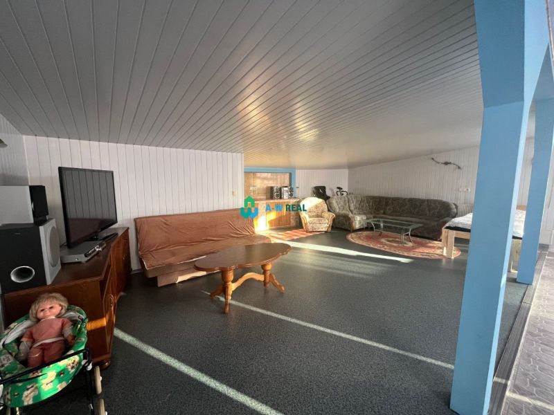 Living room with a television, sofa, and armchairs, Family house, floor with wood decor.