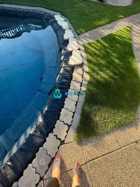 A garden at a family house in Orechová Potôň with a swimming pool and a gravel path.