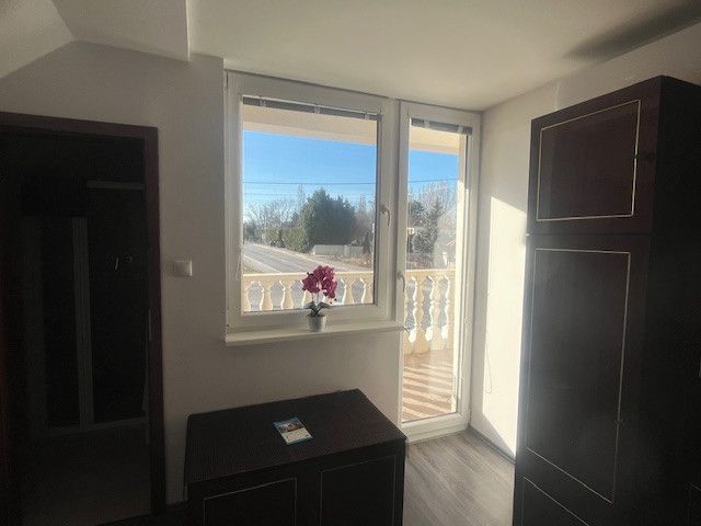 Interior with wood-patterned flooring and a view of the street.