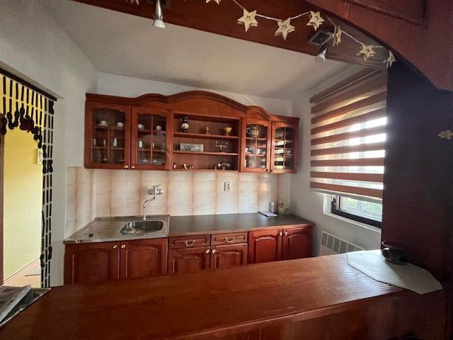 A kitchen in a family house with wooden cabinets and decorative elements.