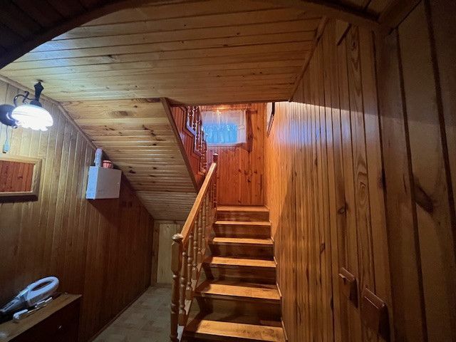 Wooden interior with staircase and lamp in a family house.